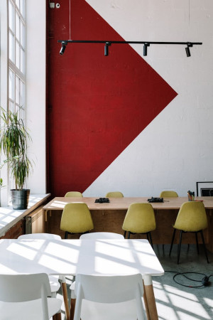 An empty office with tables and chairs.