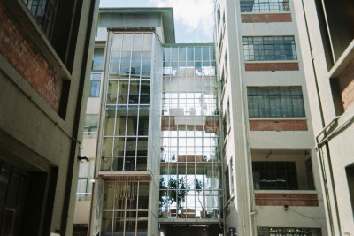 An apartment building with large glass windows.