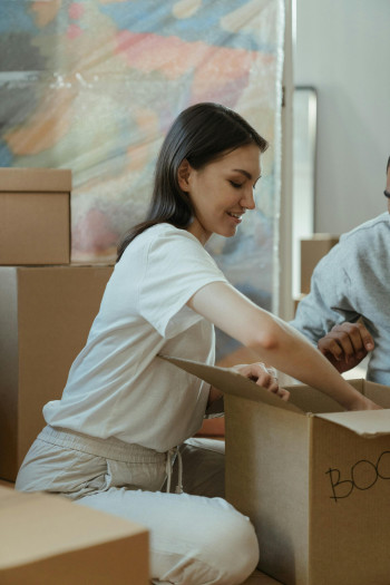 Woman unpacking a box in her new home.