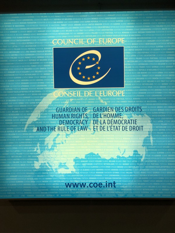 Council of Europe logo projected over image of European continent